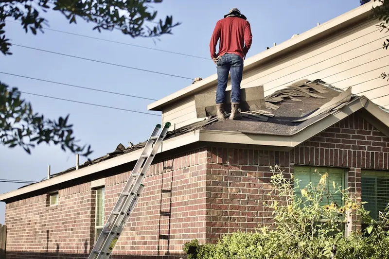 Professional roofer working on a residential roof in North Liberty
